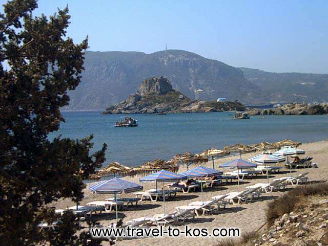 BEACH - The sandy beach of Agios Stefanos area and at the opposite side you can see the small rocky island called Kastri. 