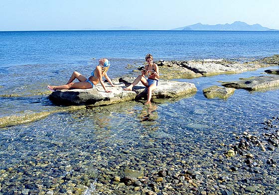 GIRLS - Two girls on a rock in Kardamena beach