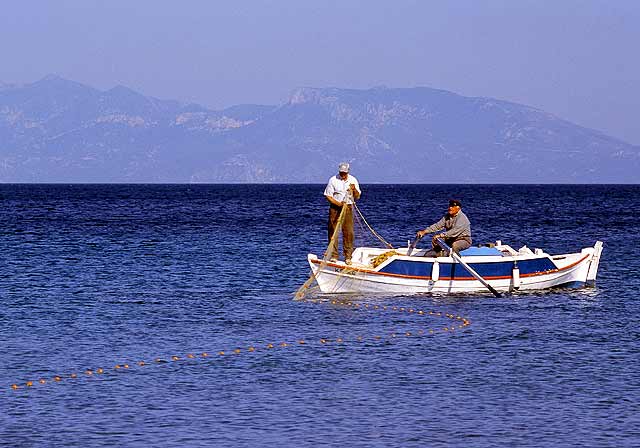 FISHERMEN - Two fishermen placing their nets