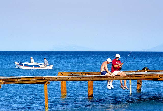 FISHING - Fishing in Kardamena, a small fishing boat in the background