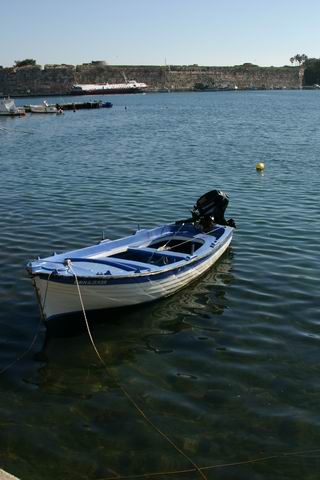 Old Port of Kos - A fishing boat and a view of Old Kos Port by nikos douzinas