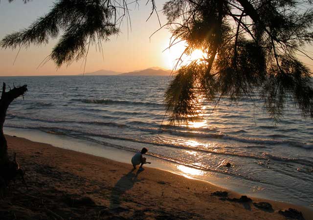 Sunset over Childhood - This is from the Greek island of Kos, somewhere from an endless beaches between Lampi (a part of the Kos town) and Tigaki, on the northern coast. On the horizon there can be seen a smaller island Pserimos.
My wife, passionately loving sea and sunsets, was so excited that she returned to her childhood (when she could only dream about being at the seaside). She started to play a game called in Slovak 