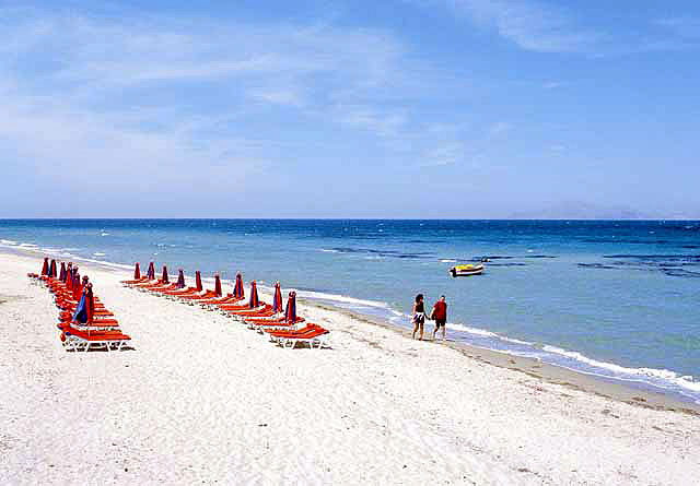 The beach in Tingaki is semi organised with umbrellas  